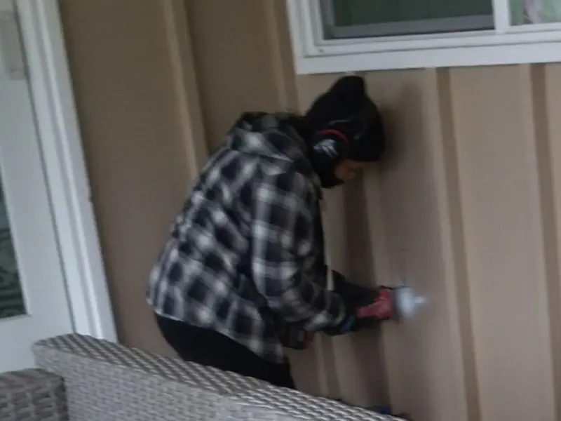 Professional electrician installing an exterior outlet in Cochran